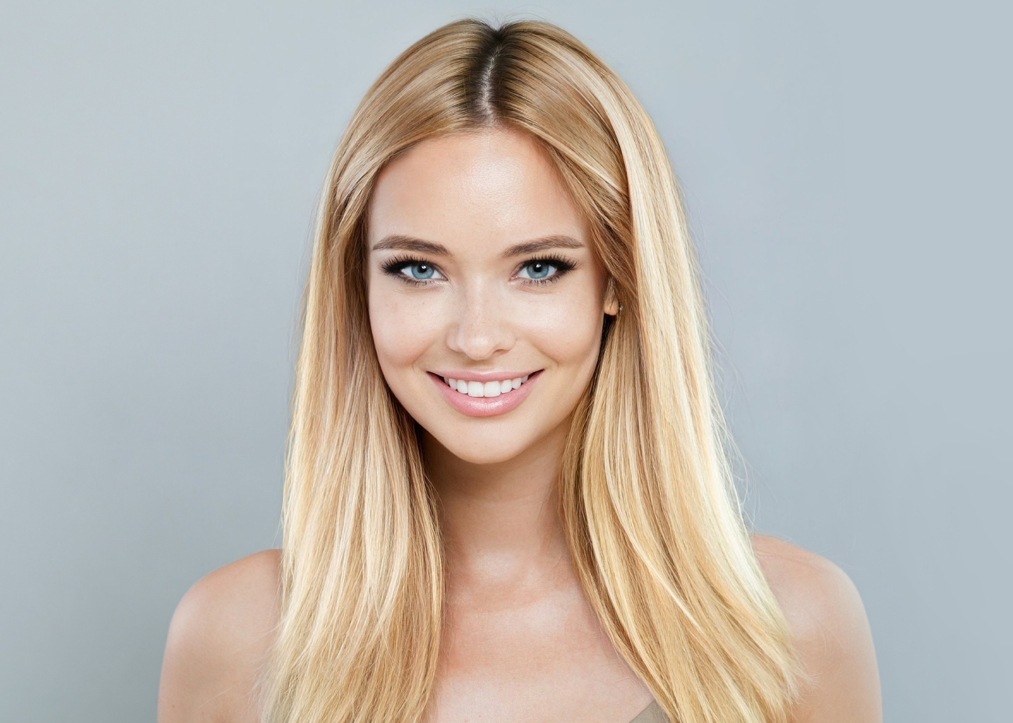 Portrait of a smiling woman with radiant skin and blonde hair