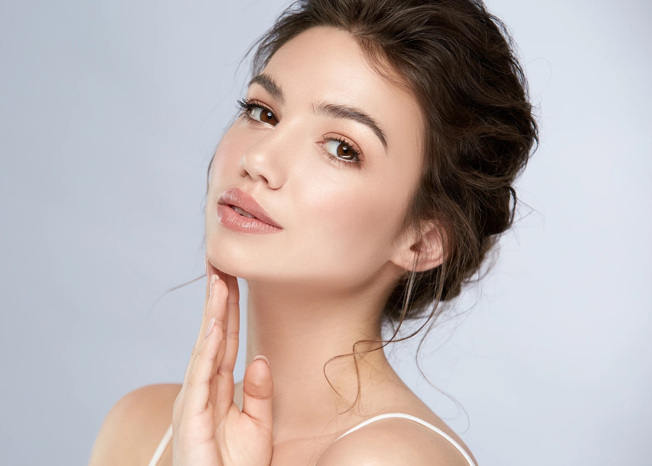 woman smiling touching the side of her face